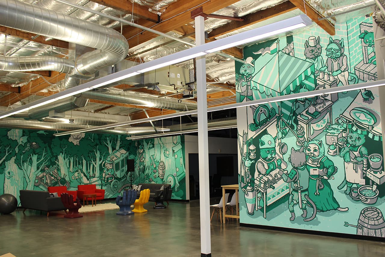Wide shot of the real Robinhood Palo Alto office with cat murals on the walls
